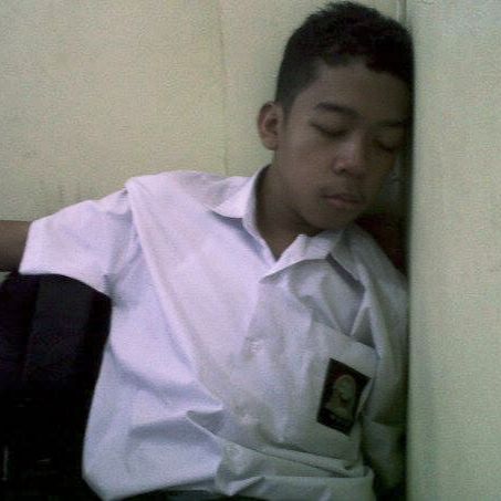 Reva in his vocational school uniform, dozing off against a wall